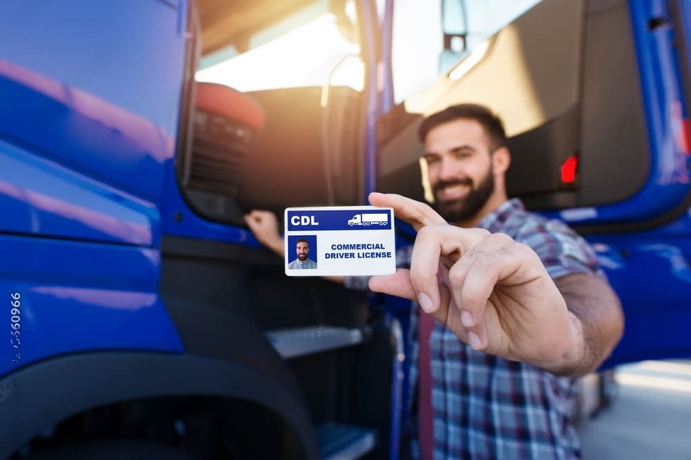 A man showing his CDL in camera 