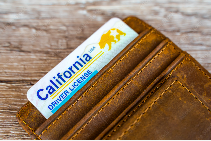 A California Driver license in a leather wallet.